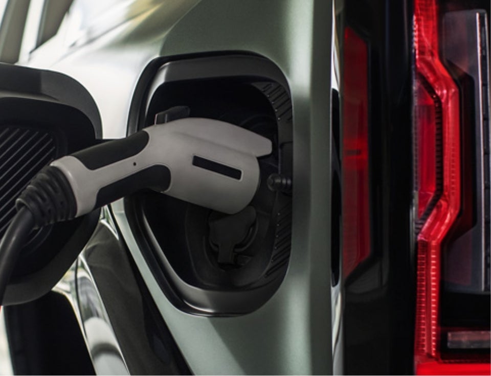 Close up of charging port with charger plugged in on a GMC Hummer EV SUV - Keller Motors GMC in hanford CA